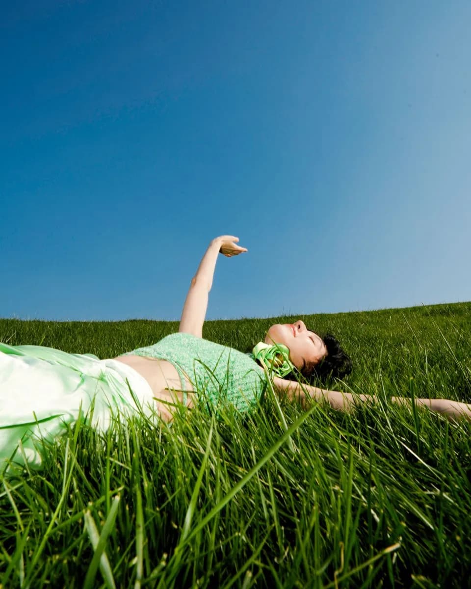 A customer lying back in a sunlit meadow.